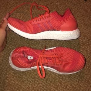 Orange Adidas Ultra Boost tennis shoes